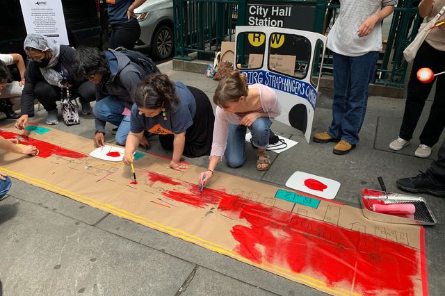A photo of bus lane advocates painting a mural